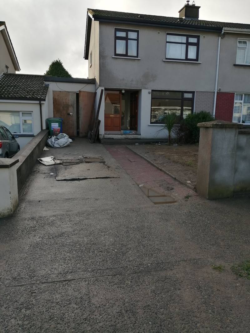 The front of the house in Ardnore, Kilkenny, before the work: an old concrete drive and a paved path